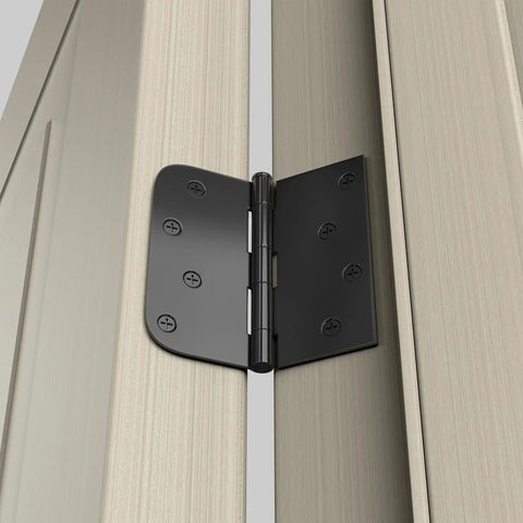Pro Grade Matte Black Interior And Exterior Door Hinges 4 inch square hinge on a door, showcasing iron construction and color matched screws.