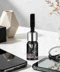 Glass Repair Liquid For Cracks And Scratches Portable Scratch Remover Quick Fix For Mobile Phones Watches Mirrors Windshields And Household Glassware Easy To Use bottle with a brush cap on a table with cracked phone screens and a watch.