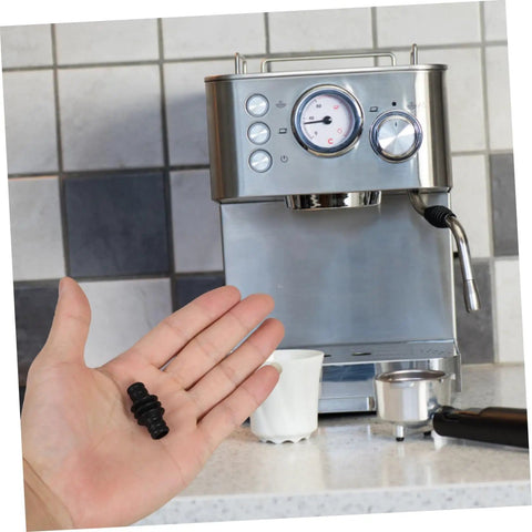 Person holding Heatproof Rubber Steam Wand Cover for Espresso Machine Pro Grade Insulation Sleeve near espresso machine.