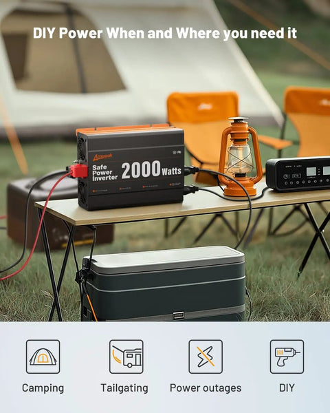 Heavy Duty 2000 Watt DC To AC Inverter Converts 12 Volts No Fuss To 110 Volts With Quick Charge Ports on a camping table.