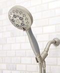 Rio Handheld Shower Head With 5 Sprays And 2.5 GPM Flow In Brushed Nickel, mounted on tiled bathroom wall