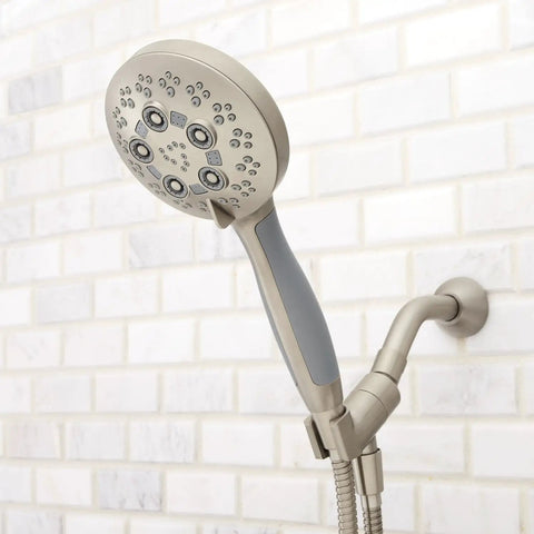 Rio Handheld Shower Head With 5 Sprays And 2.5 GPM Flow In Brushed Nickel, mounted on tiled bathroom wall