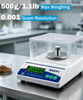 Top Notch Pro Grade Lab Scale 500g X 0.001g Digital Balance with backlit display on a lab bench with calibration weight
