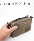 Person holding Heavy Duty Waxed Canvas Belt Pouch With YKK Zippers For Men And Women, EDC Waist Pack, Olive, Medium
