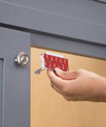 Hand installing adhesive cabinet latch set for child safety, peel and stick quick install, no tools needed, disengage when not in use.