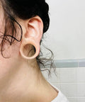Close-up of ear wearing 16mm flesh-tone silicone tunnel from Sixteen Millimeter Silicone Flesh Tone Ear Gauges Tunnels Plugs Set