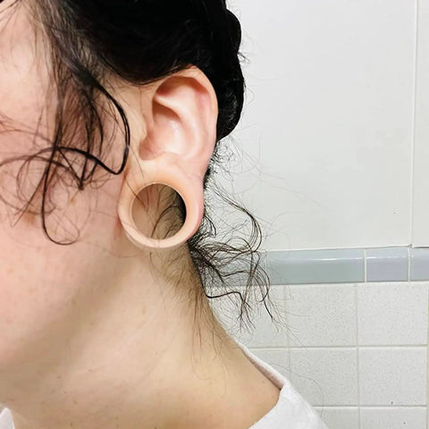 Close-up of ear wearing 16mm flesh-tone silicone tunnel from Sixteen Millimeter Silicone Flesh Tone Ear Gauges Tunnels Plugs Set