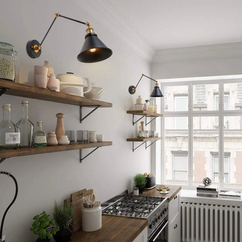 Black Swing Arm Wall Lamp With Antique Brass Finish above kitchen shelves, showcasing adjustable arm design for flexible lighting.