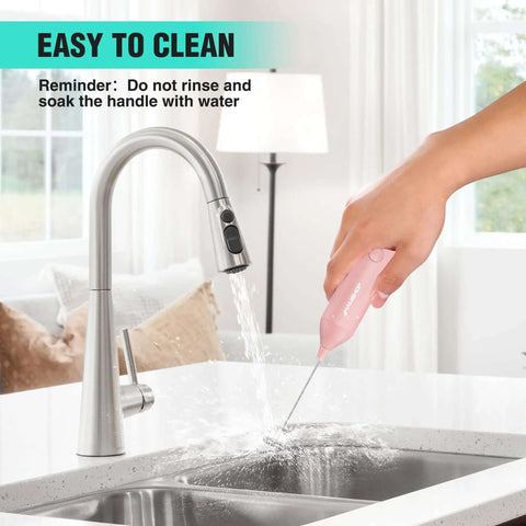 Person cleaning Powerful Rechargeable Milk Frother Wand With Stand, Handheld Electric Foam Maker, Pink, near a kitchen sink