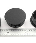 Black Nylon Hole Plugs For 1 1/8 Inch Holes With Locking Tabs, shown with ruler for scale, 6 Pack