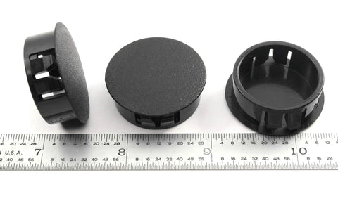Black Nylon Hole Plugs For 1 1/8 Inch Holes With Locking Tabs, shown with ruler for scale, 6 Pack