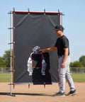 Ballpark Ready Heavy Duty Baseball Pitching Screen With Strike Zone Backdrop And Batter Silhouette For Batting Cage Drills, set up outdoors.