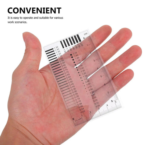 Hand holding a High Precision Measuring Ruler for Crack Width and Diameter Defect Detection in Work Sites, Durable Plastic Flaw Gauge