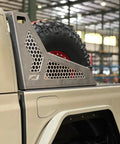 Side view of Chase Rack For Jeep Gladiator JT - Desert Inspired, Heavy Duty 11 Gauge HRPO Steel Rack with tire mounted, indoors.