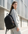 Underseat Personal Item Backpack For Travel And College Carry On Flight Approved By Ryanair, woman outdoors with black backpack.