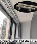 Heavy Duty Curtain Track System With Double Ceiling And Wall Mount Quiet Rollers For Room Divider And Sliding Doors In Champagne Finish Ideal For Living Room Bedroom And Closet 4.7 Meter Length Or 15.4 Feet installed on window with city view.