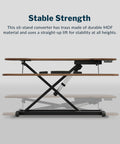 Vari Pro Plus 36 Electric Standing Desk Converter In Stylish Walnut Finish side view showing stable lift mechanism and MDF material.