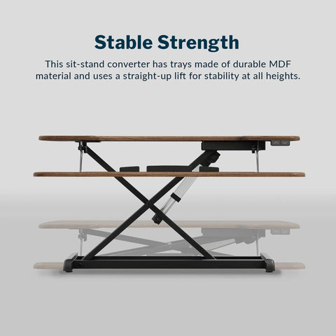 Vari Pro Plus 36 Electric Standing Desk Converter In Stylish Walnut Finish side view showing stable lift mechanism and MDF material.