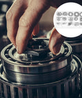 Hand installing 175 Piece Black External C Clip Shaft Retaining Rings Snap Ring Kit For Industrial Use on machinery