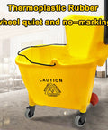 Thermoplastic Rubber 3-inch wheels on Rubbermaid WaveBrake bucket with caution sign in commercial setting.