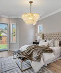 23 Inch 9 Light Gold Glass Chandelier 3 Tier Round Crystal Pendant Light Height Adjustable For Dining Room Foyer Living Room, stylishly illuminating a modern bedroom.