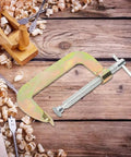 Heavy Duty G Clamp For Woodwork And Welding Fixtures 10 Inch Size With Heat Treated Carbon Steel Body placed on wood shavings