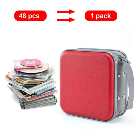 Slick Hard Plastic CD Case With Secure Slim Zipper Stores Forty Eight Discs next to stacked optical media discs.