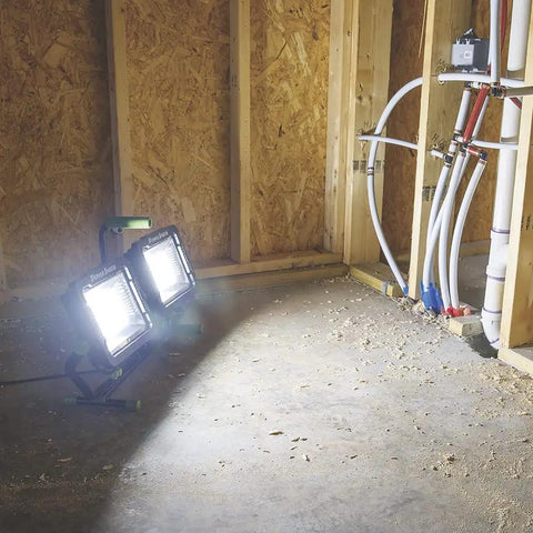 20,000 Lumen Dual Head LED Work Light With Adjustable Tripod illuminating construction site walls and floor