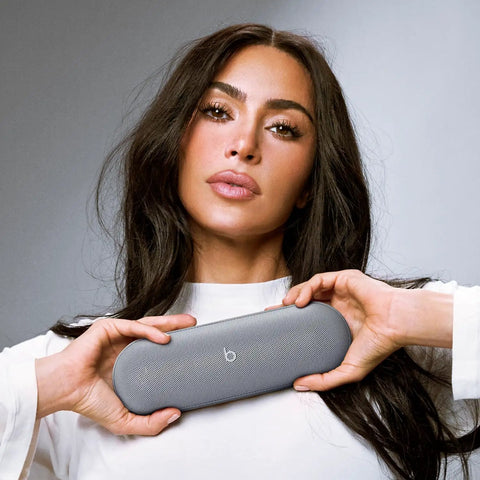 Woman holding All Day Battery Wireless Bluetooth Speaker With USB C Charging Punchy Bass Up To 24 Hours Of Battery Life IP67 Water Resistant Built In Mic Apple And Android Compatible Dark Gray Portable Party Speaker