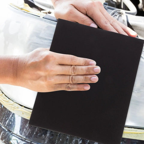 Top Notch Wet And Dry Sandpaper Assortment Pack With 60 To 320 Grit Sheets in use on an auto surface for polishing.