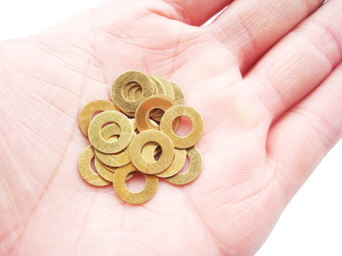 EDC Pocket Knife Brass Washer Gasket Replacement Set For C81 C223 C85 Pivot Pin Washers in hand view, 0.3x11x5.2mm, Pack of 20 Pieces