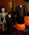 Black flameless LED candles with moving flame effect, 7-inch pillars, set of 2, with Halloween decor and remote timers, battery operated.