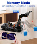 Toy 4DOF robotic arm kit on black base with joystick, orange wires, and smartphone app control.