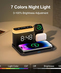 Must Have All In One MagSafe Wireless Charging Station With Alarm Clock And Night Light Five In One Dock For iPhone 17 16 15 14 13 12 Pro Max Plus Apple Watch Series 11 10 9 8 And AirPods Perfect Bedroom Nightstand Organizer featuring 7 color night light and digital clock on bedside table.