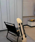 Sweet Set Of Four Portable Folding Table Legs Crafted From Skateboards And Longboards With Protective Floor Pads next to a black chair.