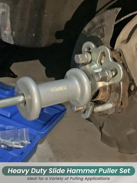 Close-up of Slide Hammer Puller Set 19 Piece With Front Wheel Hub Bearing Remover mounted on a vehicle axle for repair.
