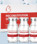 Front view of three 10 mL clear glass reconstitution solution vials with silver caps beside a white and red box.