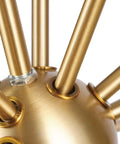 Close-up of matte brass rods on Novogratz Celeste 4 Light Chandelier In Matte Brass Dope Modern Glam Ceiling Fixture With Open Frame Design.
