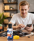 Person using Scratch Removal Kit For Screens And Glasses, 100Ml Repair Cream System on phone with other devices on desk