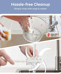Cleaning the 8-cup glass bowl and blades of Food Processor Chopper And Meat Grinder with 2 speed settings under running water.