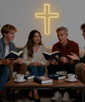 Group gathering in cozy space with lit Cross LED Neon Sign for Wall Decor USB Powered Glow Light for Bedroom and Kids Party.