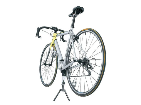 Portable Bike Stand For On The Go Tune Ups with a bike, compact foldable display stand fits 26 inch and 700C wheels, lightweight aluminum.