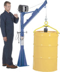 No Sweat Industrial Workhorse 115V AC Jib And Davit Crane With 1500 Lb Capacity lifting a yellow barrel with a man beside it.