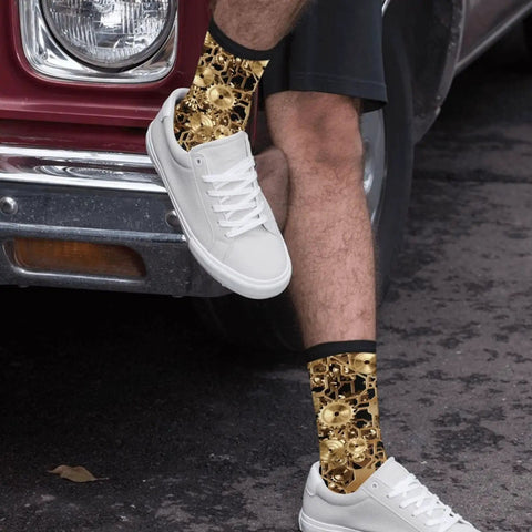 Person wearing Clockwork Gearhead Engineer Crew Socks For Men And Women with brass cogs, alongside white sneakers.
