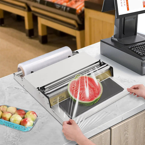 Rock Solid No Sweat Hand Cling Wrap Sealer And 18 Inch Food Packaging Machine used to seal a sliced watermelon in a commercial kitchen.