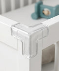 Transparent PVC corner guard on crib, part of Four Pack PVC Corner Guards for Furniture and Tables, No Tools Needed, Easy Install Edge Protectors.