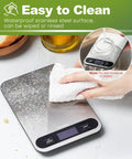 Cleaning digital kitchen scale with 33lb capacity, 1g precision, backlit LCD, stainless steel surface, wipeable design, black