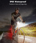 Cyclist using Ultra Slim USB Rechargeable Bike Lights Front And Rear Set for night riding in rain, showcasing IP65 waterproof feature.