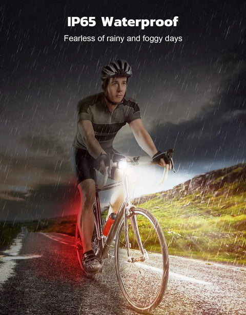 Cyclist using Ultra Slim USB Rechargeable Bike Lights Front And Rear Set for night riding in rain, showcasing IP65 waterproof feature.
