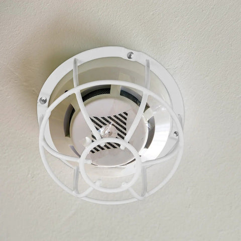Built Damn Tough Fire Sprinkler Head Protector Wire Cage Guard For Ceiling Mount Installations shows white cage over sprinkler head.
